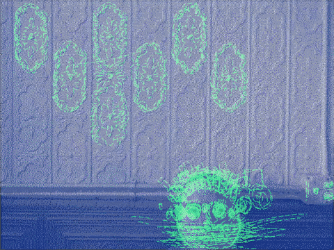 A photo of me standing in front of a painted tin wall with green scribbling on top