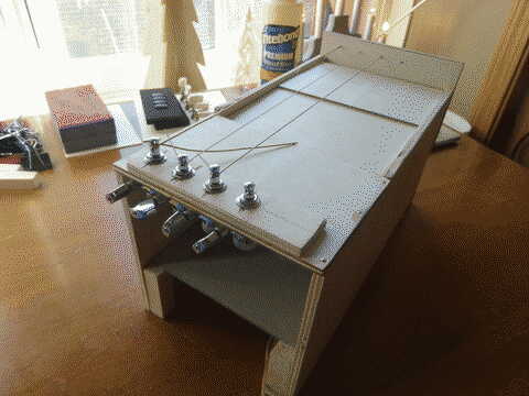 A prototype feedback resonator, which looks essentially like a wood box with some strings on the top